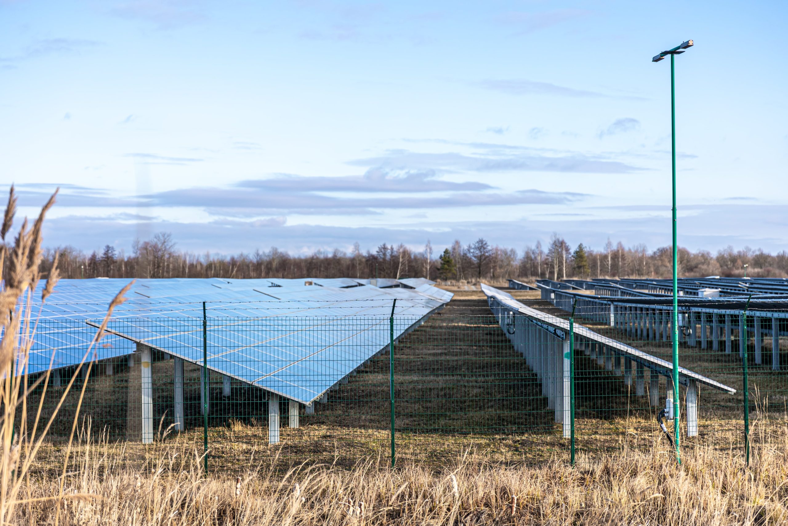 Solar panels installed in a green field for agriculture use