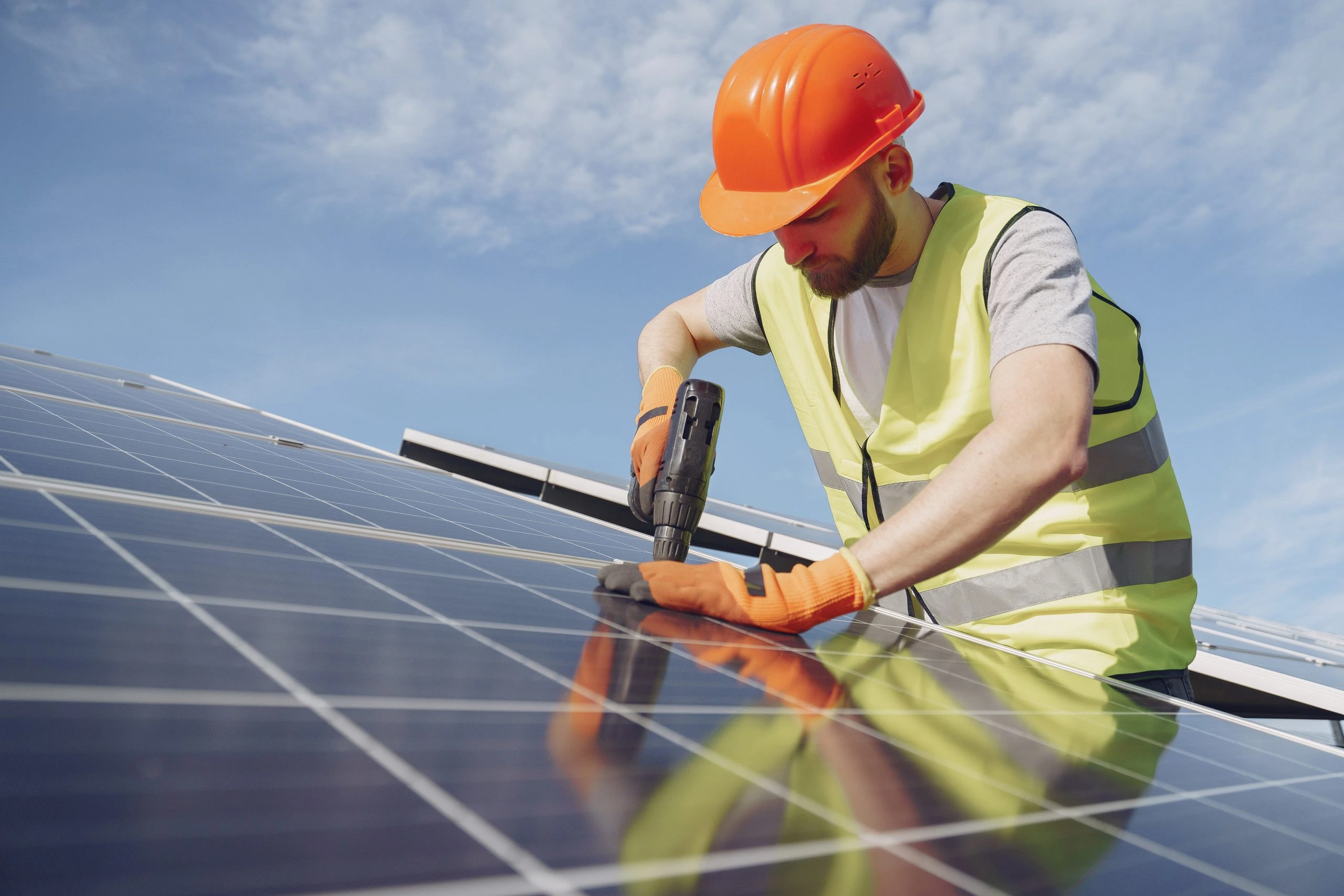 Solar panel worker standing in front of solar panels